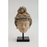 GANDHARAN CLAY HEAD OF A BODHISATTVA The curled banded hair with ushnisa, ebonized wood stand. 9 3/4