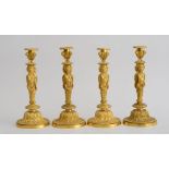 SET OF FOUR LOUIS XVI STYLE GILT-BRONZE CANDLESTICKS