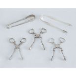 THREE PAIRS OF GEORGE III SILVER SCISSOR-FORM SUGAR NIPS AND TWO PAIRS OF TONGS