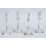 SET OF FOUR CRICHTON BROS. CRESTED AND WEIGHTED SILVER CANDLESTICKS IN THE QUEEN ANNE STYLE