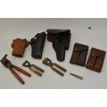 A collection of leather gun holsters including 45c