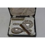 A silver dressing table set comprising two brushes