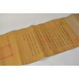 A Chinese imperial scroll with text and gold drago