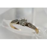 An 18ct gold and platinum ring the solitaire diamo