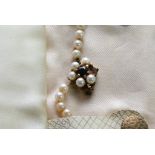 A pearl necklace with 9ct gold clasp in wallet, on