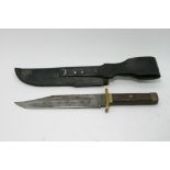 A Bowie knife in leather sheath