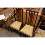 A pair of Edwardian chairs with drop in seats on s