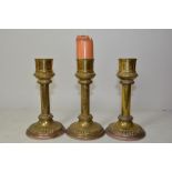 Three circular brass candlesticks with classical d