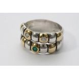 A two tone gold band ring set with diamonds and a