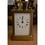 A French brass case carriage clock the enamel dial