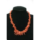 A coral necklace with silver clasp.