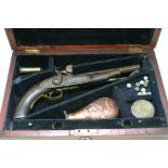 A percussion pistol in fitted case with accessorie