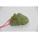 A Chinese carved jade pendent in  the form of dragon