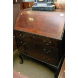 A mahogany bureau with a fall front and fitted int