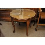 A walnut occasional table the circular top on cabr