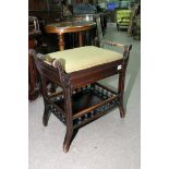 A mahogany piano stool with galleried undertier.