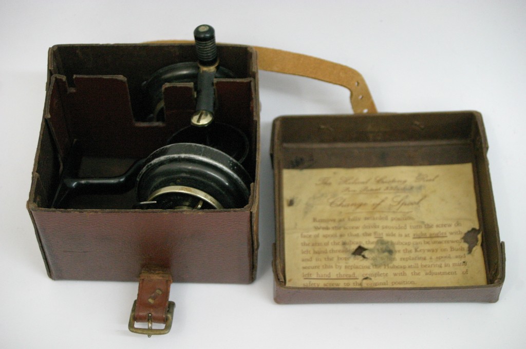 A vintage Helical Casting reel in original leather