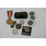 A collection of coins, medal and SAS badge.