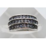 A 9ct white gold ring set with three rows of tanzanite stones.