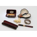 Two cased gold mounted cheroot holders, a cased Meersham pipe and a Victorian expanding braclet