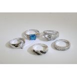 A collection of five silver rings inset with various stones