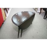 A dark wood Ercol drop leaf occasional table