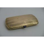 A 20th century continental gilt metal card case with blue stone cabochon