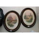 A pair of oval framed oil on canvases of English rural landscapes, one depicting a windmill, the