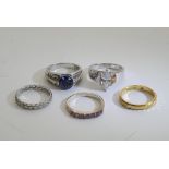 A collection of five silver rings inset with various stones