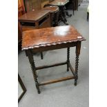 An oak 1920s table having barley twist legs