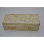 A rectangular carved ivory box decorated in relief