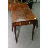 A Georgian Pembroke table on turned legs with caster feet