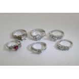 A collection of six silver rings inset with various stones