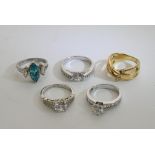 A collection of five silver rings inset with various stones