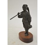 A Japanese, bronze figure in traditional dress carrying a hoe, on a mahogany base