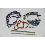 A silver ring and one other, gem stone bracelet, three costume necklaces and another bracelet.