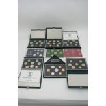 Nine cased UK proof coin sets