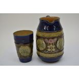 A Royal Doulton jug and conforming beaker commemor