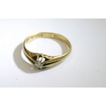 An 18ct gold gypsy ring inset with a single diamon