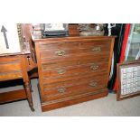 An Edwardian walnut three piece bedroom suite comprising a two door wardrobe, wash stand and