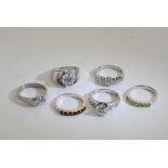 A collection of six silver rings inset with various stones