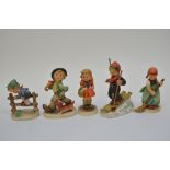 A collection of five Hummel figurines including Hu