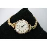 A 9ct gold ladies Rolex watch, the enamel dial wit