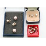 A collection of pearl earrings and a small diamond