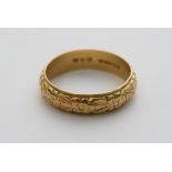 A gold wedding band ring marked 916