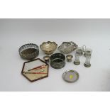 A collection of silver plated wine coasters and od