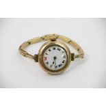 A 9ct gold watch, the enamel dial with Roman numer