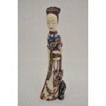 A carved and painted ivory figure of a female cour