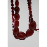Two 1940's cherry red bead necklaces, one restrung