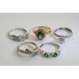 A collection of five silver rings inset with various stones